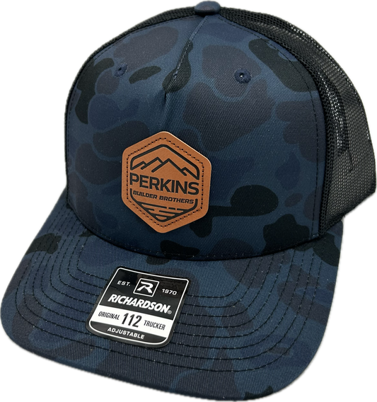 Debossed Faux Leather Patch - Richardson 112PFP Snapback Trucker Hat - Admiral Duck Camo/Black - Perkins Builder Brothers